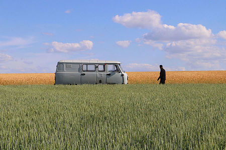 Russian monk in the Steppe with his old Soviet car